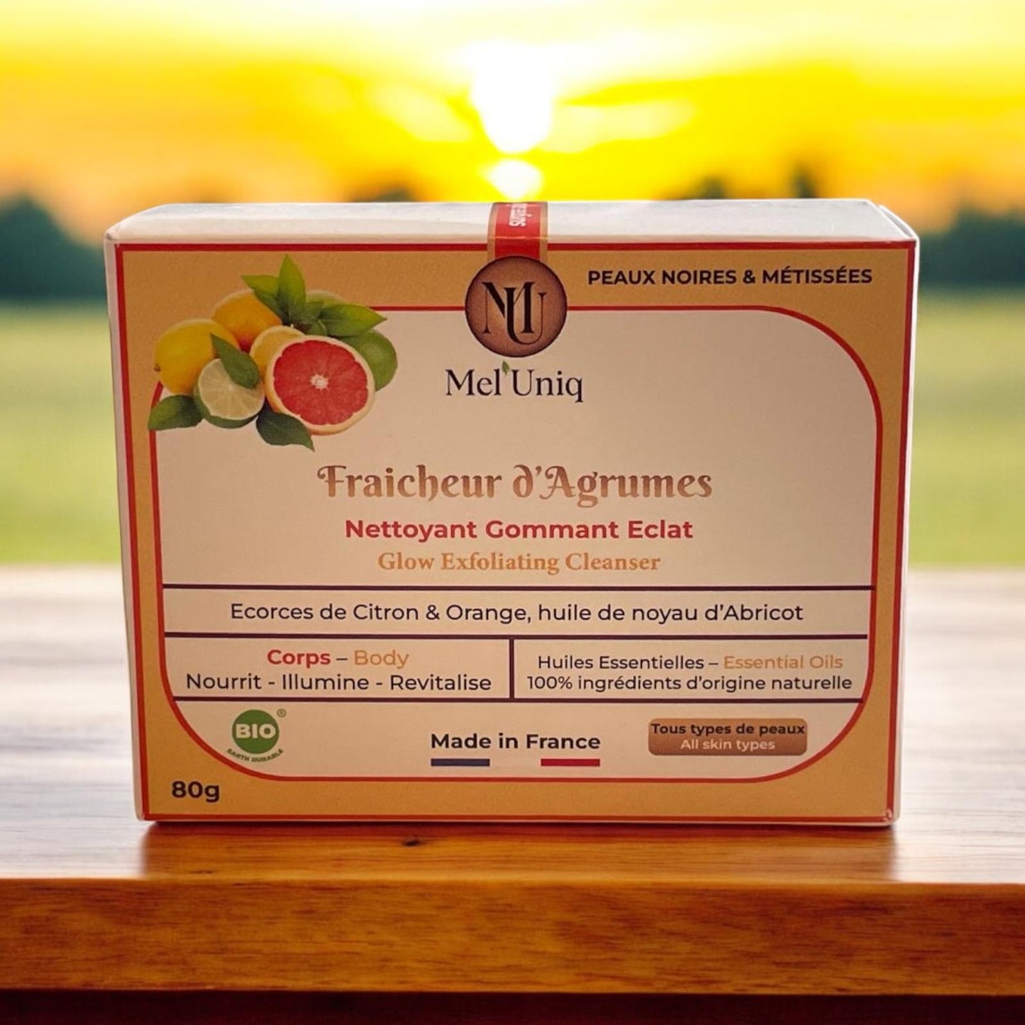 savon Fraicheur d'Agrumes Mel'Uniq sur fond de soleil couchant