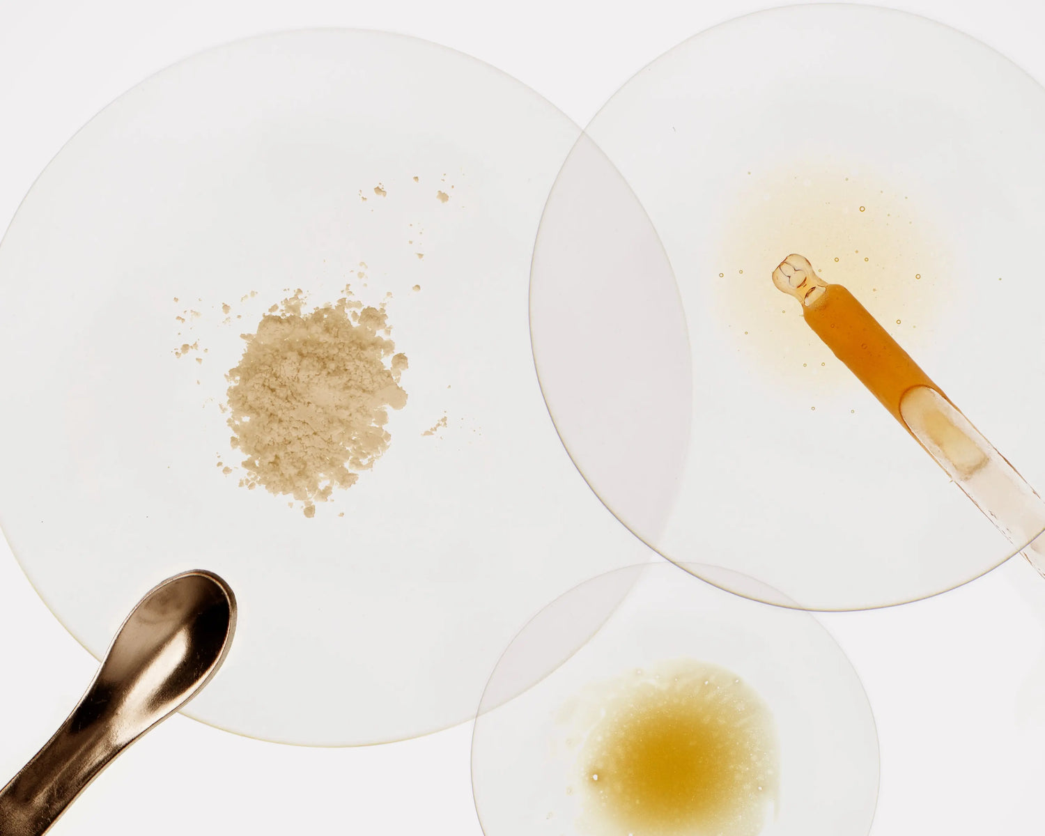 Poudre cosmétique et pipette de sérum Mel’Uniq sur fond clair, illustrant la mixologie et l’association des actifs.