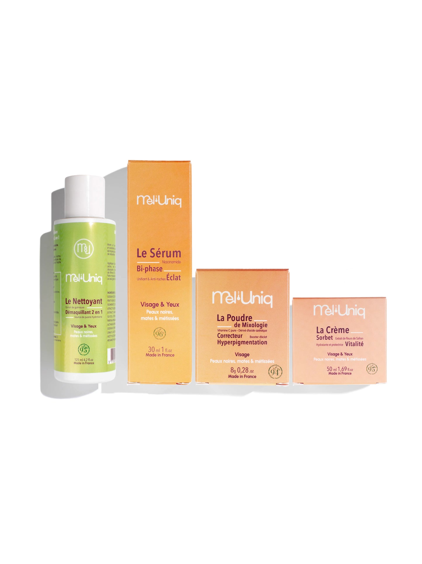 Routine anti-taches visage Mel’Uniq composée de quatre soins pour peaux noires et métissées : nettoyant, sérum bi-phase, poudre correctrice et crème hydratante éclat.